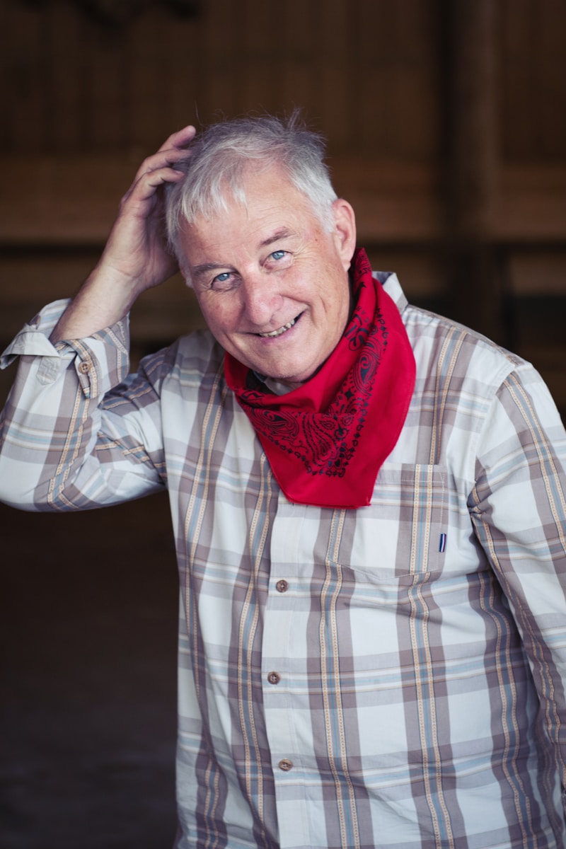 man in white and black plaid dress shirt wearing red scarf one of the experienced drivers you can hire