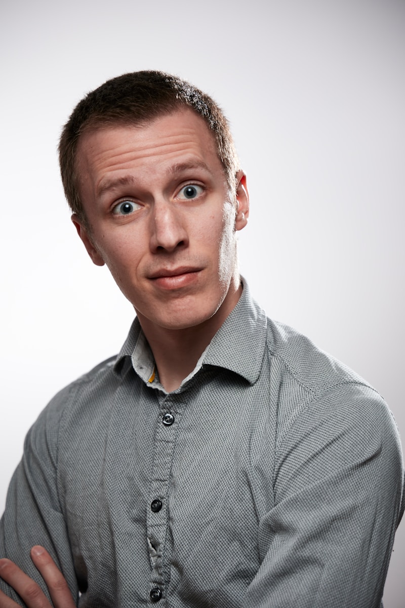 man wearing a gray button up shirt with professional liability insurance answers